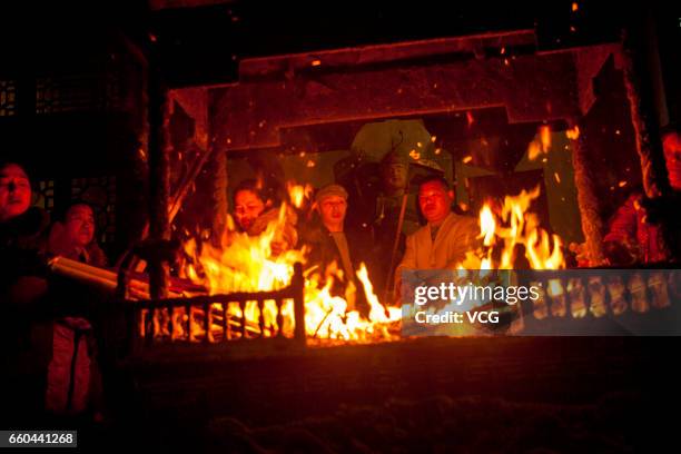 People crowd at Zhenwu Mountain to burn incense during the Sanyuesan Festival on March 30, 2017 in Xiangyang, Hubei Province of China. Thousands of...