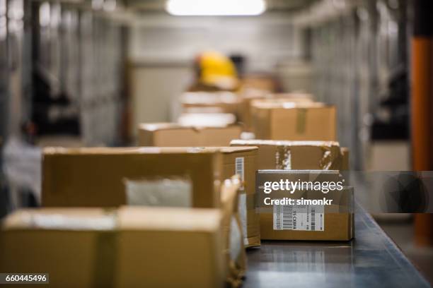 boxes on conveyer belt - delivering package stock pictures, royalty-free photos & images