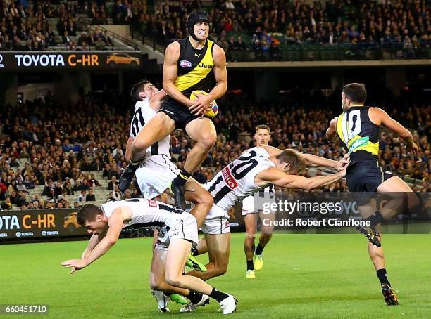 Ben Griffiths of the Tigers takes a mark during the round two AFL match between the Richmond Tigers and the Collingwood Magpies at Melbourne Cricket...