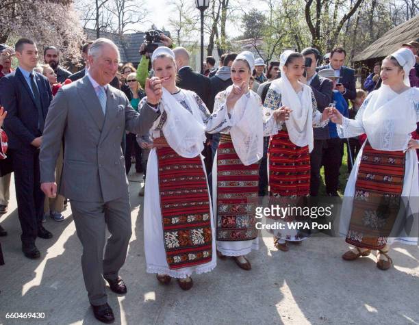 Prince Charles, Prince of Wales dances with Romanian dancers at a village museum on the second day of his nine day European tour on March 30, 2017 in...