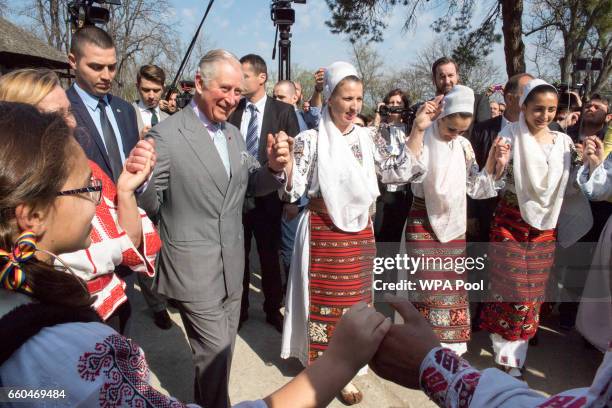 Prince Charles, Prince of Wales dances with Romanian dancers at a village museum on the second day of his nine day European tour on March 30, 2017 in...