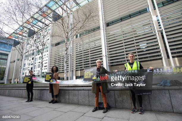 Activists hold up a giant paper chain and placards during a demonstration in front of the Home Office on March 30, 2017 in London, England. Amnesty...