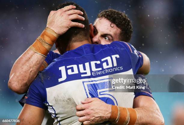 Adam Elliot of the Bulldogs celebrates with Marcelo Montoya of the Bulldogs at fulltime during the round five NRL match between the Canterbury...