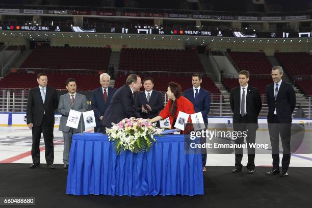 Commissioner Gary Bettman and Bloomage Chairman & Executive Director Zhao Yan sign an agreement during the press conference held by National Hockey...