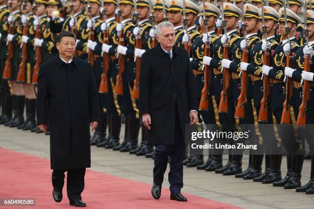 Chinese President Xi Jinping accompanies Serbian President Tomislav Nikolic to view a guard of honour during a welcoming ceremony outside the Great...