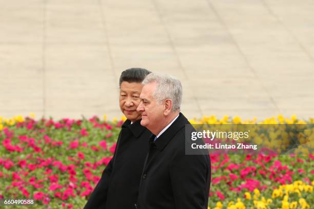 Chinese President Xi Jinping accompanies Serbian President Tomislav Nikolic to view a guard of honour during a welcoming ceremony outside the Great...