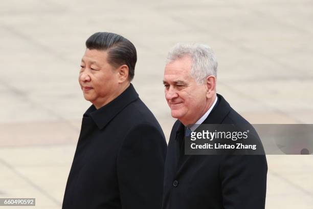 Chinese President Xi Jinping accompanies Serbian President Tomislav Nikolic to view a guard of honour during a welcoming ceremony outside the Great...