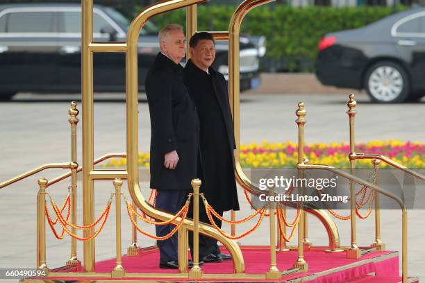 Chinese President Xi Jinping accompanies Serbian President Tomislav Nikolic to view a guard of honour during a welcoming ceremony outside the Great...