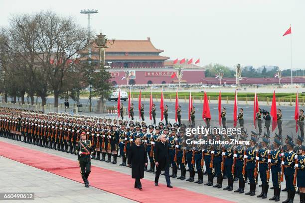 Chinese President Xi Jinping accompanies Serbian President Tomislav Nikolic to view a guard of honour during a welcoming ceremony outside the Great...