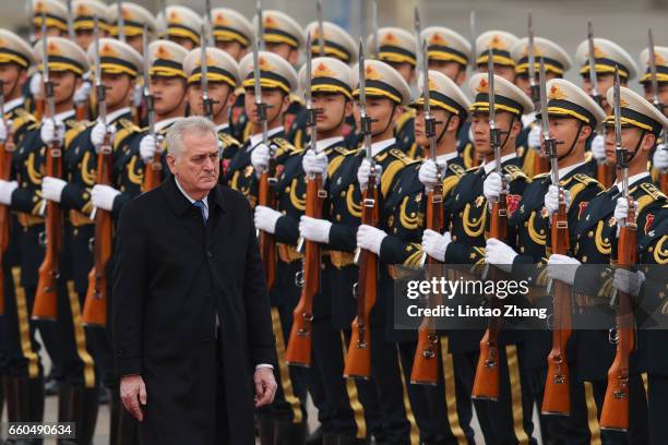 Chinese President Xi Jinping accompanies Serbian President Tomislav Nikolic to view a guard of honour during a welcoming ceremony outside the Great...