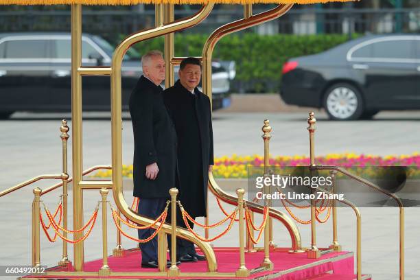 Chinese President Xi Jinping accompanies Serbian President Tomislav Nikolic to view a guard of honour during a welcoming ceremony outside the Great...