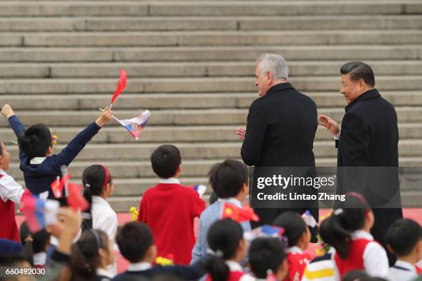 Chinese President Xi Jinping accompanies Serbian President Tomislav Nikolic to view a guard of honour during a welcoming ceremony outside the Great...