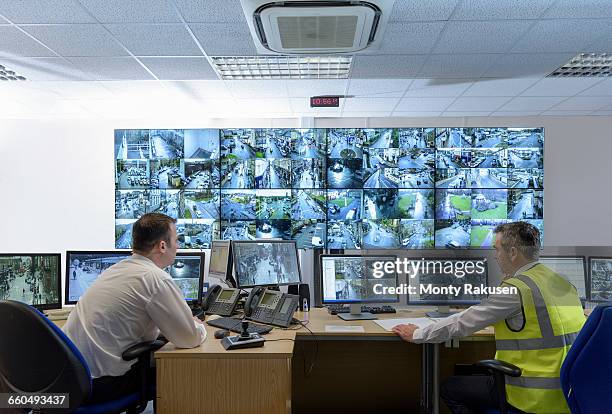 security guards in security control room with video wall - video wall stock pictures, royalty-free photos & images