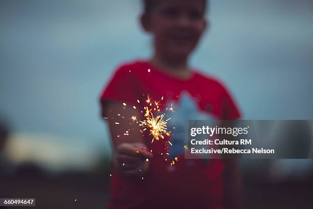 girl holding lit sparkler - cultura americana stock pictures, royalty-free photos & images