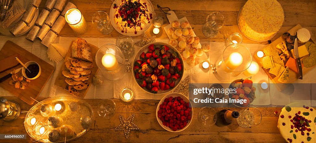 Overhead view candlelight table with Christmas desserts