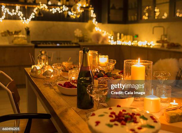 champagne and desserts on candlelight christmas table - kitchen after party stock-fotos und bilder