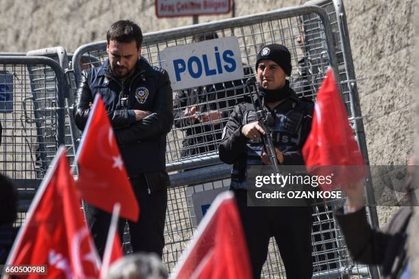 Turkish anti-riot police officers stand guard in front of a police barrier during a demonstration outside the US consulate in Istanbul against the...