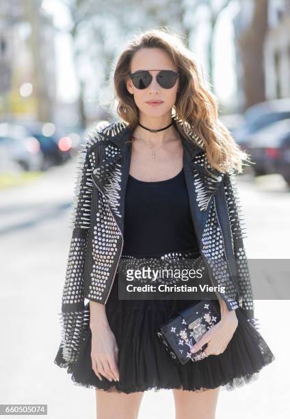 Model and fashion blogger Alexandra Lapp wearing a black leather jacket from Tigha decorated with studs and little spikes, a vintage black petticoat...