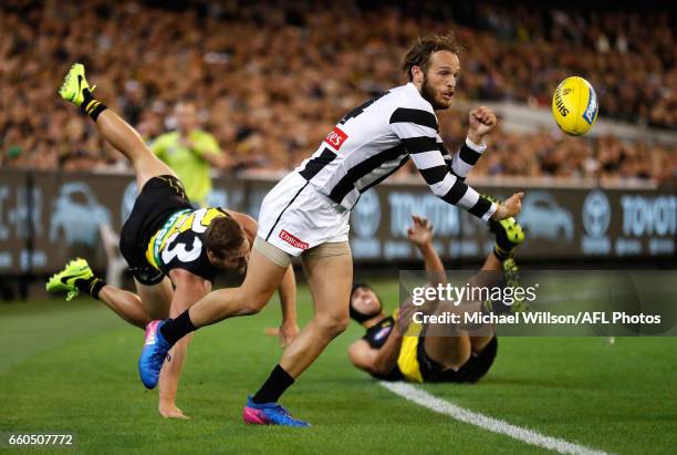 James Aish of the Magpies evades Kane Lambert and Ben Griffiths of the Tigers during the 2017 AFL round 02 match between the Richmond Tigers and the...