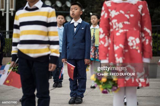 Children wait prior to a welcome ceremony with Chinese President Xi Jinping and Serbian President Tomislav Nikolic at the Great Hall of the People in...