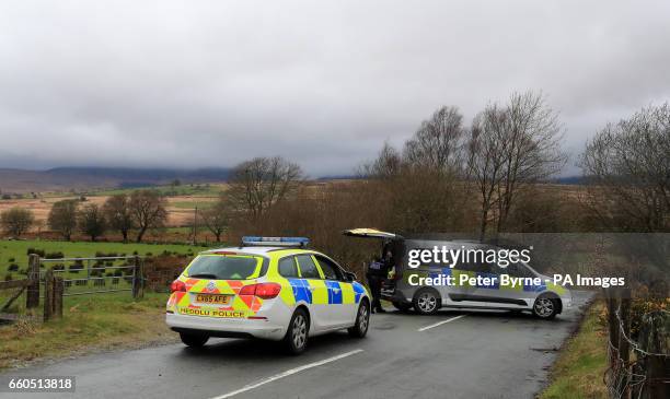 Police man a roadblock in Trawsfynydd, North Wales, where the wreckage has been discovered of a Twin Squirrel helicopter which went missing Wednesday...