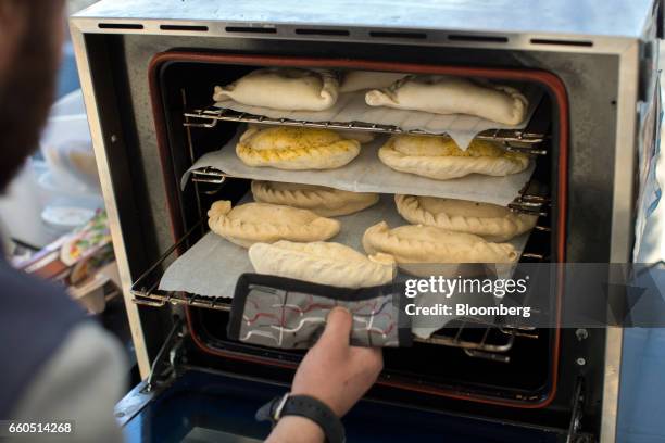 Jason Phaetos, a food vendor, prepares pasties in his mobile Cornish pastie van, Rolling Pasties, outside the European Council in Brussels, Belgium,...