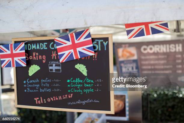 Chalk board hangs alongside British union flag, or Union Jack, bunting in a mobile Cornish pastie van, Rolling Pasties, outside the European Council...