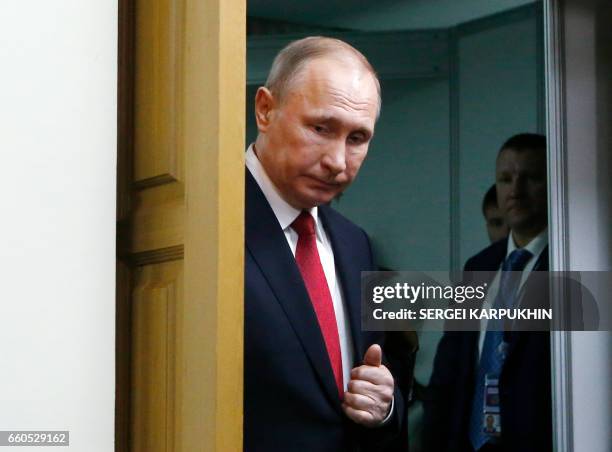 Russian President Vladimir Putin leaves after a meeting with Finnish President as part of the International Arctic Forum in Arkhangelsk on March 30,...