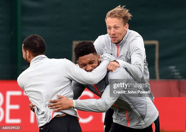 Lucas, Joe Gomez and Kevin Stewart of Liverpool during a training session at Melwood Training Ground on March 30, 2017 in Liverpool, England.