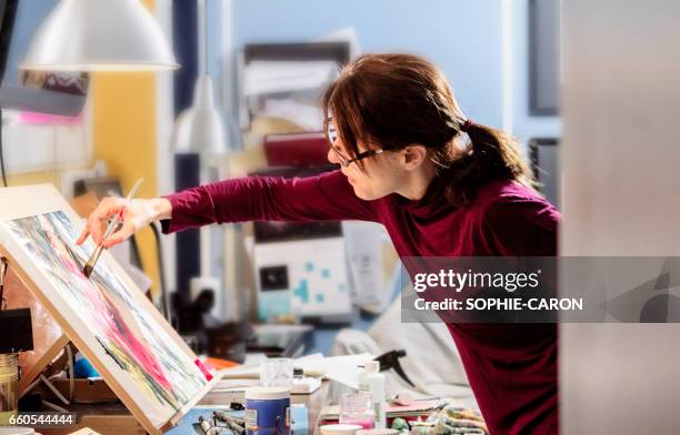 a woman and her work. - pinceau stock pictures, royalty-free photos & images