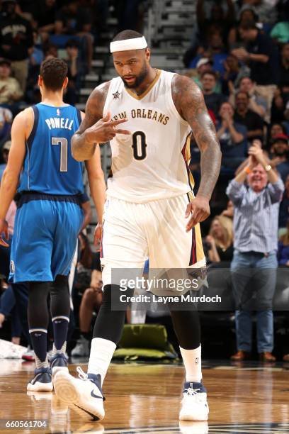DeMarcus Cousins of the New Orleans Pelicans celebrates after making a three pointer buzzer beater into halftime against the Dallas Mavericks on...