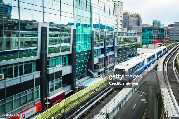 taipei, taiwan - may 01, 2016 : street view of taipei with metro train on the rail on may 01, 2016 in taipei, taiwan. the taipei mrt is one of the best way to travel around the city. - taipei mrt stock pictures, royalty-free photos & images