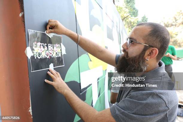Over 40 underprivileged and differently-abled children from various NGOs and graffiti artists painted the phrase 'Let's Build Tomorrow' on a wall at...