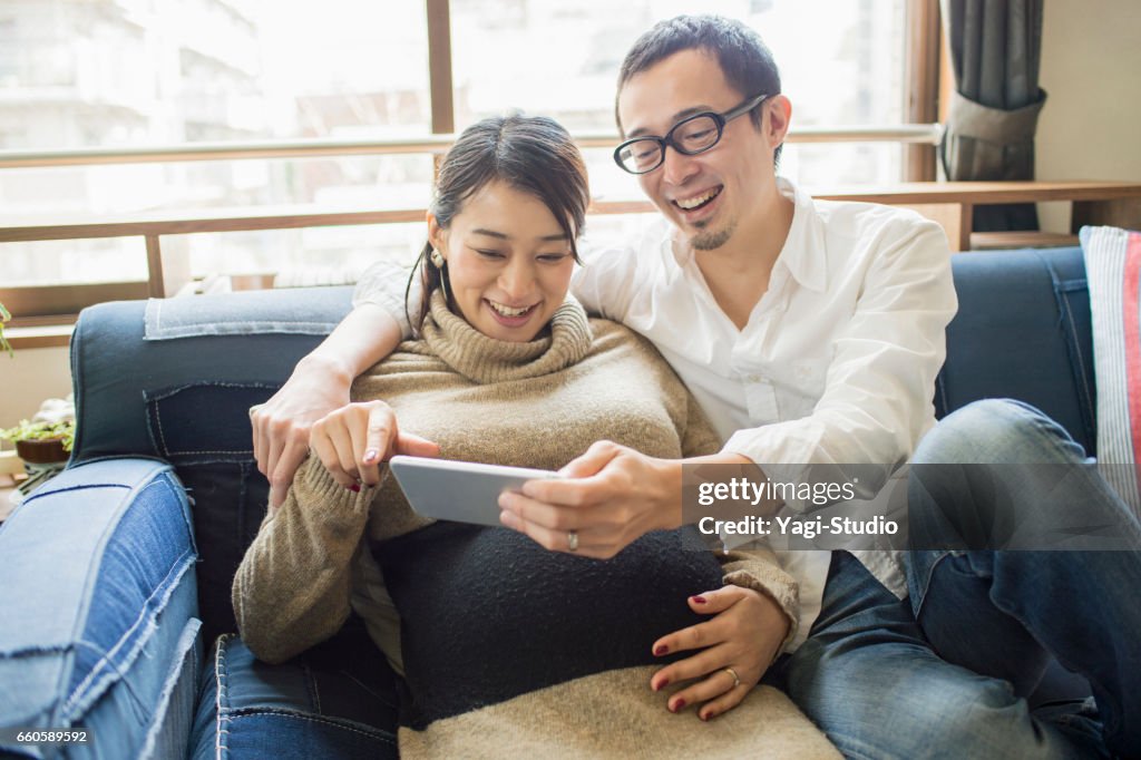 Pregnant woman with her husband in room