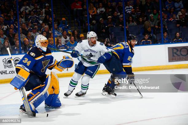 Jack Skille of the Vancouver Canucks in action against Alex Pietrangelo and Jake Allen of the St. Louis Blues at the Scottrade Center on March 23,...