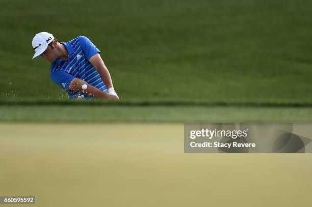 Jon Rahm of Spain hits from a greenside bunker on the 13th hole during the first round of the Shell Houston Open at the Golf Club of Houston on March...