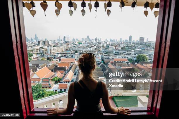 young woman explores city, looks out from overview - thailand tourist stock pictures, royalty-free photos & images