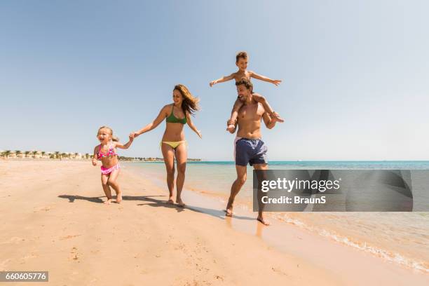 carefree family having a fun day on the beach. - egyptian family imagens e fotografias de stock