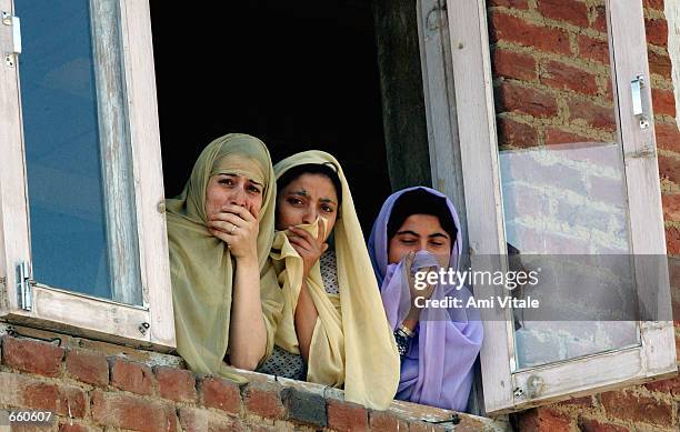 Kashmiri women watch the funeral of Fayez Ahmed Lone on June 7, 2002 in Srinagar, the summer capital of the Indian held state of Jammu and Kashmir....