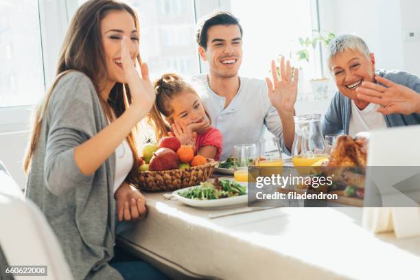 family having a video call during dinner - virtual lunch stock pictures, royalty-free photos & images