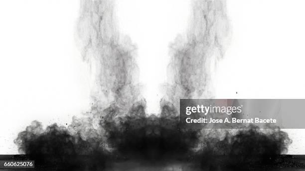 explosion of a cloud of powder of particles of  colors gray on a black and white  background - etéreo stockfoto's en -beelden