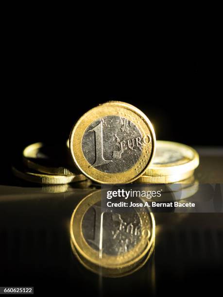 heap of one euro coins - actividades bancarias stockfoto's en -beelden