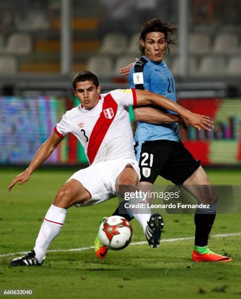 Edinson Cavani of Uruguay struggles for the ball with Aldo Corzo of Peru during a match between Peru and Uruguay as part of FIFA 2018 World Cup at...