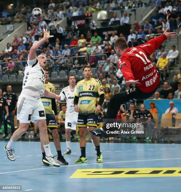 Patrick Wiencek of Kiel throws the ball over Goalkeeper Andreas Palicka of Rhein-Neckar Loewen during the EHF Champions League Quarter Final Leg 2...