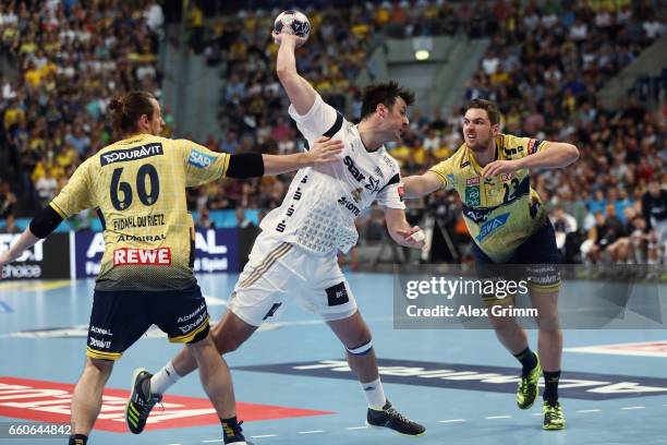 Domagoj Duvnjak of Kiel is challenged by Kim Ekdahl du Rietz and Hendrik Pekeler of Rhein-Neckar Loewen during the EHF Champions League Quarter Final...