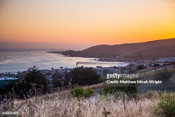 views looking over the cayucos pier at sunset. - cayucos stock pictures, royalty-free photos & images