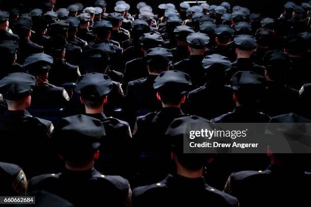 The newest members of the New York City Police Department attend their police academy graduation ceremony at the Theater at Madison Square Garden,...