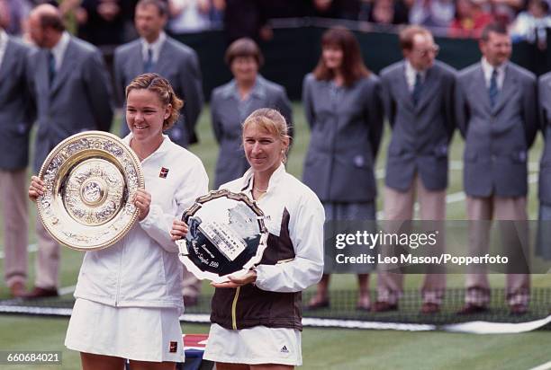 American tennis player Lindsay Davenport holds the Venus Rosewater Dish trophy after winning the final of the Women's Singles tournament against...