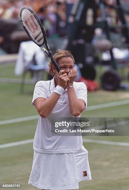 American tennis player Lindsay Davenport raises her hands to her face in surprise and celebration after winning the final of the Women's Singles...