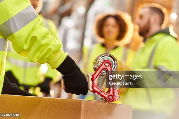 packers in a warehouse - tape dispenser stock pictures, royalty-free photos & images